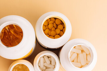 Open vitamin bottles with tablets and capsules top view. High quality photo