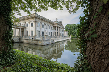 The Royal Łazienki Park in Warsaw, nestled among the trees. The Palace on the Isle. The Baroque Garden Pavilion. The Classicist-style Palace. The Łazienki Ponds. Beautiful Architecture.