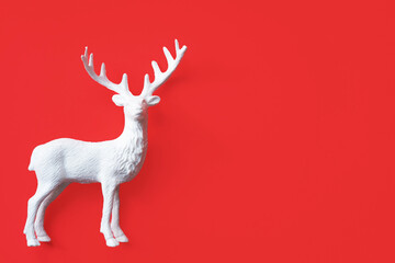 Decorative white deer figure on red background with space for text.