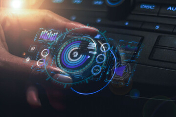 A female car saleswoman's hand demonstrates automotive technology with a virtual hologram of blue light on the dashboard.