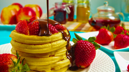 Delicious Stack of Pancakes with Fresh Strawberries and Rich Chocolate Drizzle