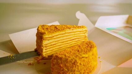 Delicious Layered Honey Cake (Medovik) Slice Being Served from a Box