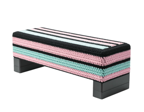 Hand-crocheted cover in black, pale pink, and mint green stripes adorns a rectangular step aerobics platform with dark gray base