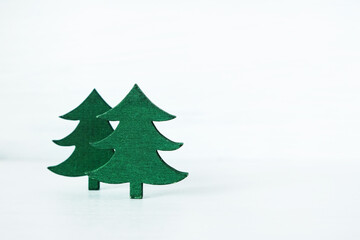 wooden miniature Christmas tree placed against a rustic gray wooden background.