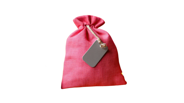 Pink Pouch with Tag: A delightful pink pouch, its texture evident, is tied with a soft string and adorned with a blank tag, perfect for personalization, against a simple backdrop.