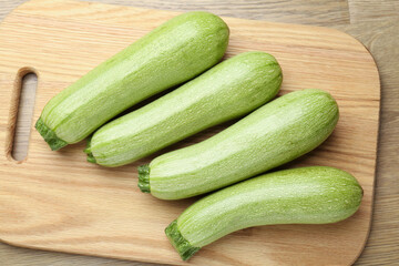 Fresh ripe zucchinis on wooden table, top view