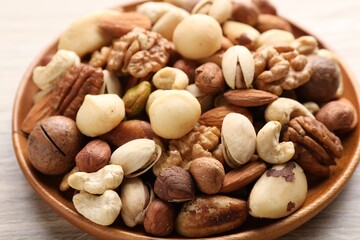 Mix of different nuts on wooden table, closeup
