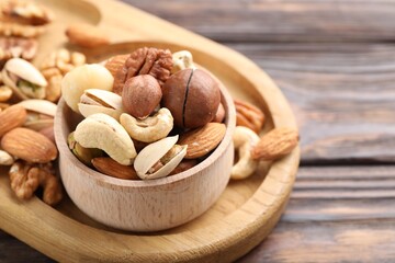 Mix of different nuts on wooden table, closeup