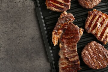 Delicious grilled beef meat on grey table, top view. Space for text