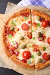 Delicious pizza with cheese, tomatoes and olives on table, top view