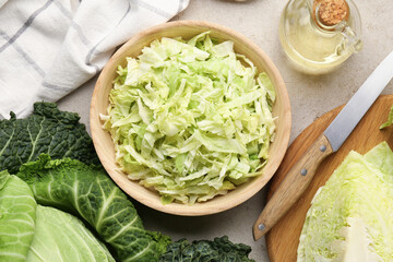 Fresh Savoy cabbages, knife and oil on light table, flat lay