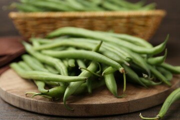 Fresh green bean pods on wooden table, closeup