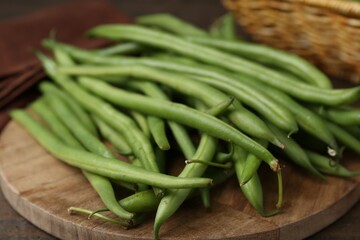 Fresh green bean pods on wooden table, closeup
