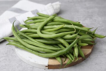 Fresh green bean pods on grey table, closeup
