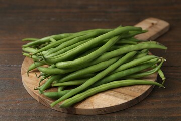 Fresh green bean pods on wooden table, closeup
