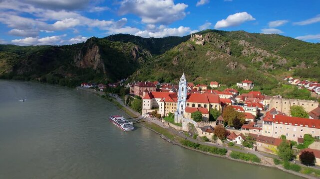 Austria tourism. Wachau valley , Danube river boat cruise. scenic village Durnstein ,aerial drone footage of colorful town and ruined castle
