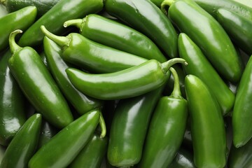Many green jalapeno peppers as background, closeup