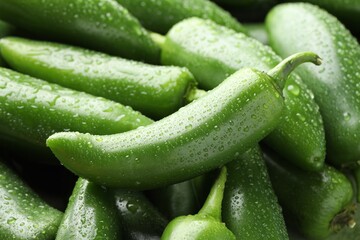 Many wet green jalapeno peppers as background, closeup