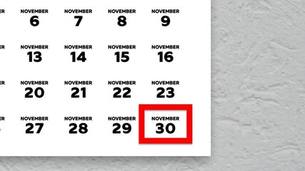 The date November 30th marked with a red cursor on the wall calendar 2025