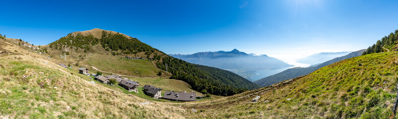 Panoramic view of Alpe di Mezzo, in Montemezzo, and Monte Berlinghera, in summer.