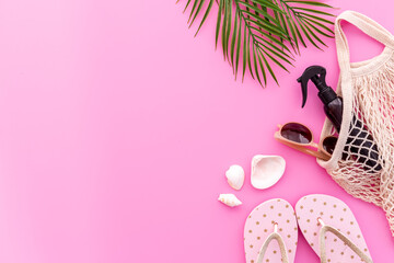Beach accessories or summer outfit with palm leaves flat lay, top view
