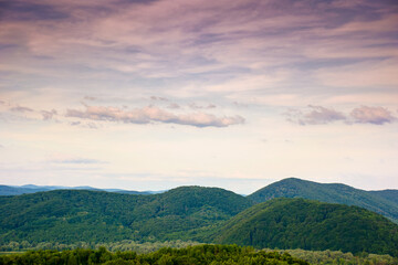 Obraz premium mountain landscape under evening sky with dramatic clouds. beautiful carpathian countryside scenery in summer. picturesque view