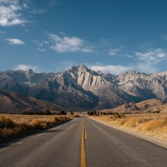 Naklejka premium Scenic highway vanishing point, leading towards majestic mountain range