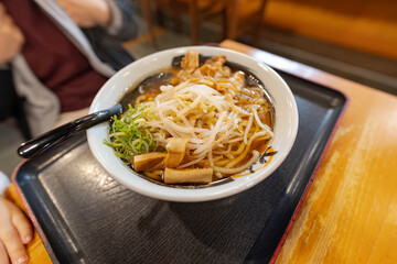 a clear pork broth soup ramen with bamboo shoots and fresh bean sprouts