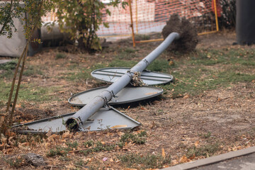 A fallen road sign in the grass in the city