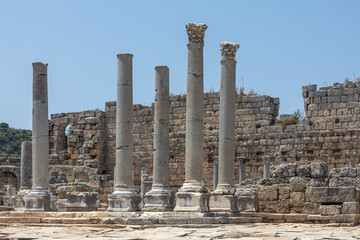 Columns and ruins of buildings in the ancient city of Perge in Turkey. An ancient city founded during the Trojan War. Smooth and elaborately crafted columns on the streets of the ancient city.