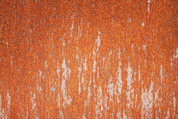 Rust on black painted metal due to environmental influences.