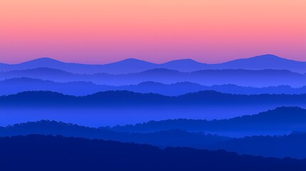 First light of dawn glowing warmly over mist-filled mountain range