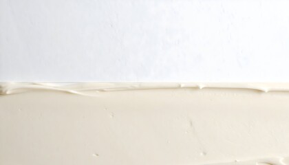 Creamy white icing or frosting swirled on a white surface