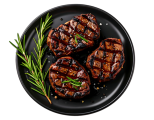 Three grilled beef filets on a black plate, garnished with rosemary sprigs and peppercorns