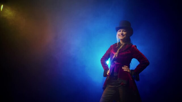 Happy young woman taking off top hat making respectful bow curtsy gesture greeting. Girl smiling face wearing bowler hat. red tailcoat frock coat suit. 18th 19th century vintage old style blue night