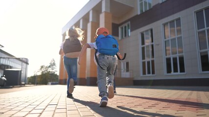 A group of girls running back to school. Bag elementary happy concept. Children running around in a backpack at lifestyle school. A group of children running back to school with their backpacks.