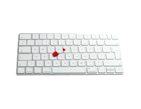 A clean white wireless keyboard with two small red drops of liquid spilled near the "G" and "H" keys