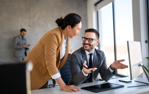 Group of young business people working as a team and communicating in corporate office