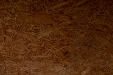 Oriented Strand Board OSB has a woodlike texture with visible strands, making it ideal for various construction and interior design applications like flooring and furniture