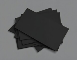 Stack of blank black business cards on a gray surface