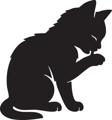 Kitten grooming licking paw.