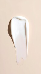 Creamy white moisturizer smudged on a beige background