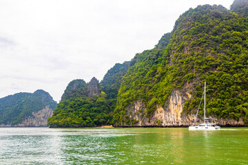 Limestone rocks hills turquoise green water Phang Nga Bay Thailand.