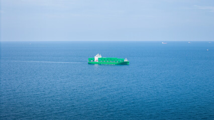 Green Cargo Container Ship, Cargo Container only green color. container ship running in the ocean to shipyard sea port. import shipping freight logistics. Concept green transportation environment