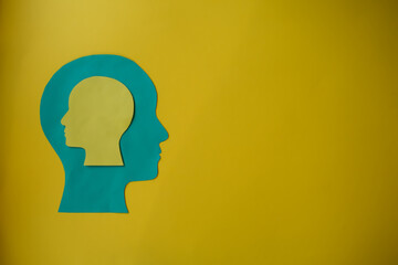 A paper cutout of a head with another head inside it.