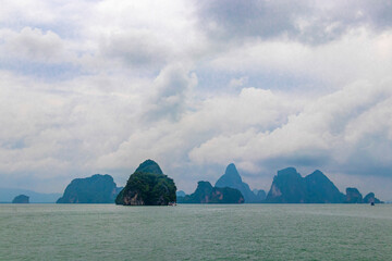 Limestone rocks hills turquoise blue water Phang Nga Bay Thailand.