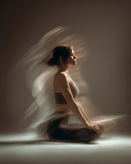 Fototapeta premium Calm Woman in Yoga Pose with Artistic Motion Blur Effect