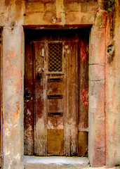 An old wooden door with a number 18 above it.