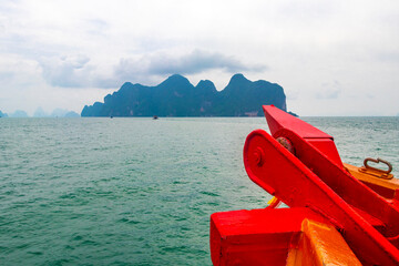 Limestone rocks hills turquoise water boat Phang Nga Bay Thailand.