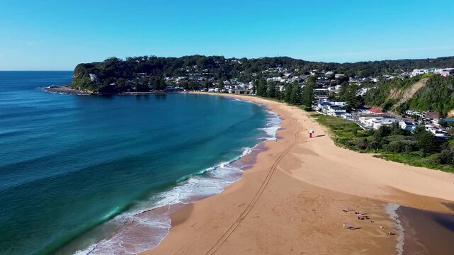 Drone aerial landscape of beautiful Avoca Beach town and coastal suburbs with ocean waves crashing on the shoreline at the scenic coastline headland destination Central Coast Australia travel nature